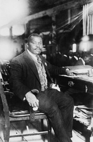 : Marcus Garvey, National Hero of Jamaica, full-length, seated at desk